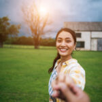 Woman walking on romantic happy holidays holding hand of boyfrie